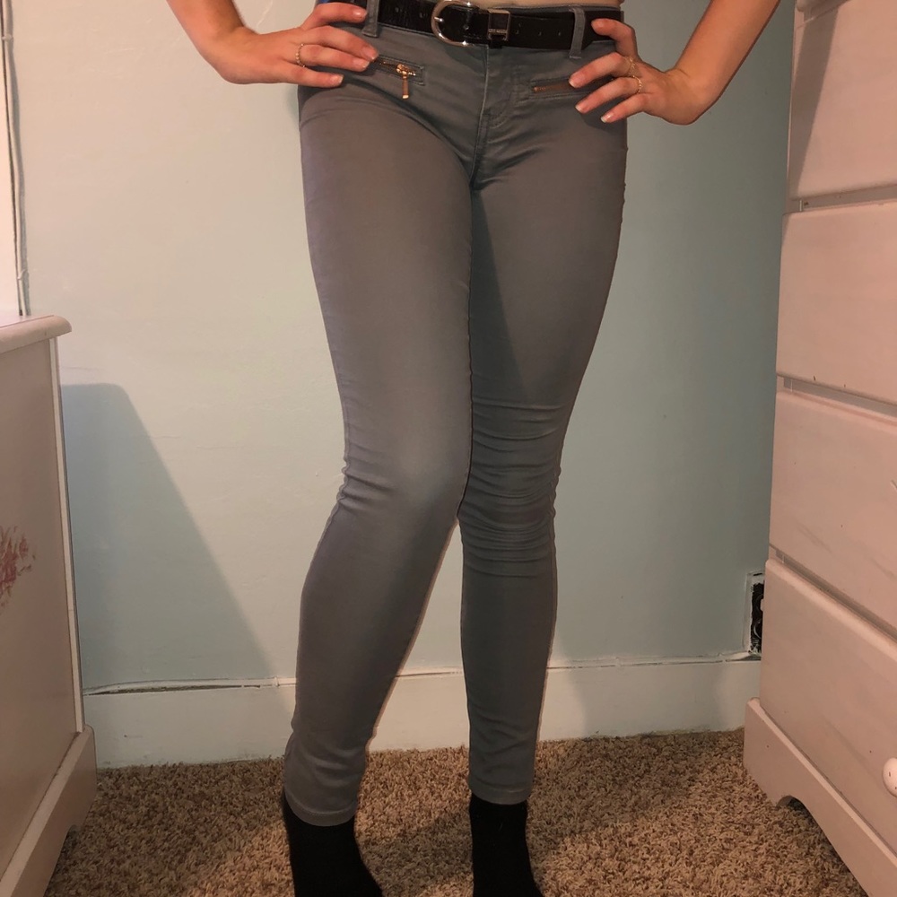 grey jeans w a painted cherry on the pocket